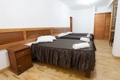 a bedroom with a bed with towels on it at Hotel El Huarango in Ica