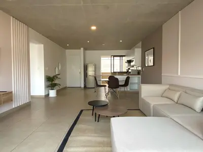 a living room with a white couch and a table at Modern Penthouse & 2BR in Miraflores by Wynwood House in Lima