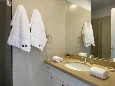 a bathroom with a sink and a mirror and towels at Modern Penthouse & 2BR in Miraflores by Wynwood House in Lima