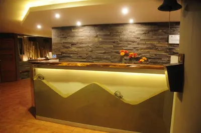 a kitchen with a counter with a stone wall at Hotel El Huacachinero- Hotel Familiar in Ica