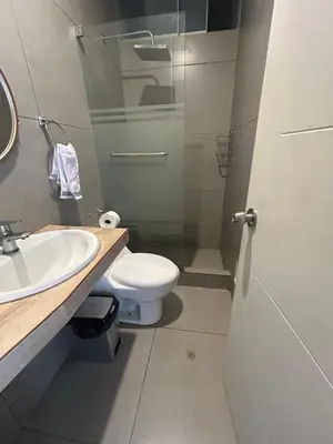 a bathroom with a toilet and a sink and a shower at Departamento de Playa (con piscina propia) en km 107 Asia, Lima in Asia