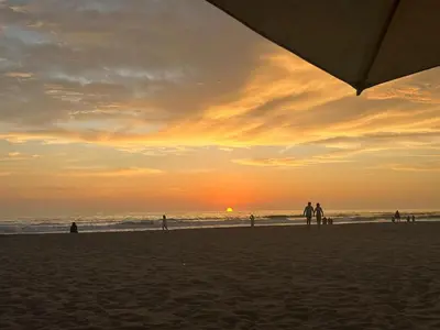 a group of people on the beach at sunset at Departamento de Playa (con piscina propia) en km 107 Asia, Lima in Asia