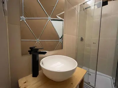 a bathroom with a white bowl sink and a shower at Pacucha Glamping in Andahuaylas