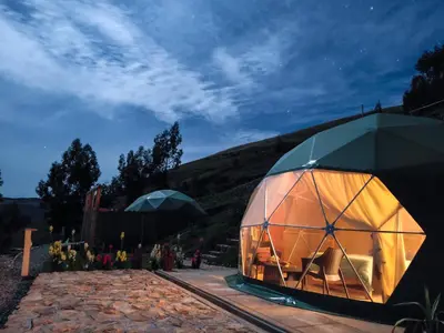 a large dome tent sitting on top of a field at Pacucha Glamping in Andahuaylas