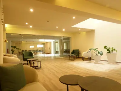 a lobby with couches and chairs and tables at Muña Hotel Andahuaylas in Andahuaylas