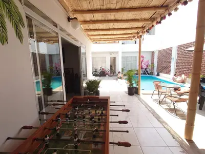 a room with a foosball table and a pool at Hostel Killamoon Centro in Paracas