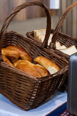 a basket filled with bread sitting on top of a table at Rockrivers Plaza MachuPicchu in Machu Picchu