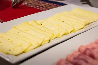 a white plate of cheese on a table at Rockrivers Plaza MachuPicchu in Machu Picchu