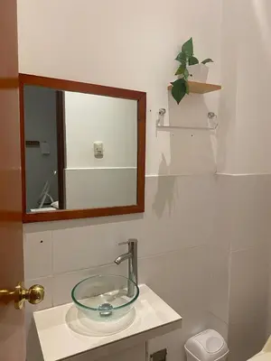 a bathroom with a glass sink and a mirror at Millennium Hotel Corporative in San Vicente de Cañete