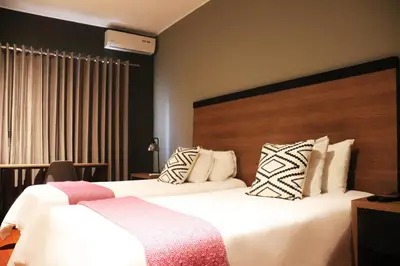 a hotel room with two beds and a large headboard at The Lot Boutique in Lima