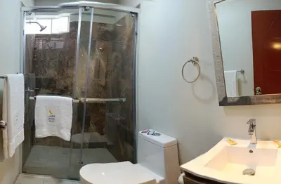 a bathroom with a shower and a toilet and a sink at Arabian Hotel in Lima