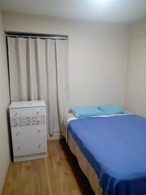 a bedroom with a bed and a dresser and a window at Habitación nueva para persona sola o pareja in Lima