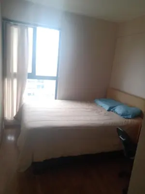 a bedroom with a large bed with a window at Habitación nueva para persona sola o pareja in Lima