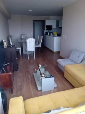 a living room with a couch and a table at Habitación nueva para persona sola o pareja in Lima