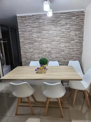 a dining room table with white chairs around it at Departamento amplio y acogedor San Miguel in Lima