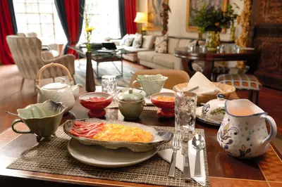 a table with a plate of food on top of it at Palacio Manco Capac by Ananay Hotels in Cusco