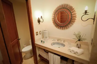 a bathroom with a sink and a toilet and a mirror at Palacio Manco Capac by Ananay Hotels in Cusco