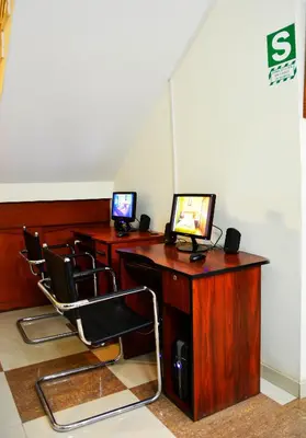 a room with three desks with computers on them at Hotel Sol del Sur in Nazca