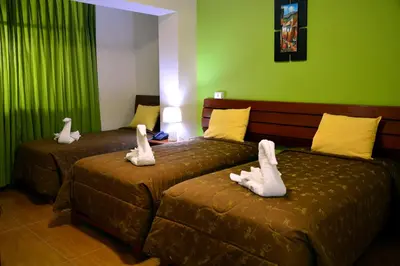 two beds with stuffed animals on them in a room at Hotel Sol del Sur in Nazca