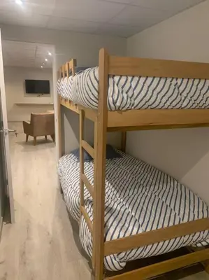 a couple of bunk beds in a room at Apartamentos WANCA SUITES para 4, 5 y 6 huéspedes cochera muy cerca al Centro in Huancayo