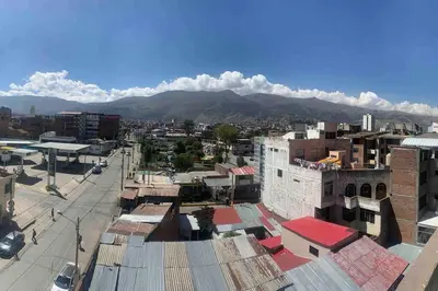 a view of a city with mountains in the background at Apartamentos WANCA SUITES para 4, 5 y 6 huéspedes cochera muy cerca al Centro in Huancayo