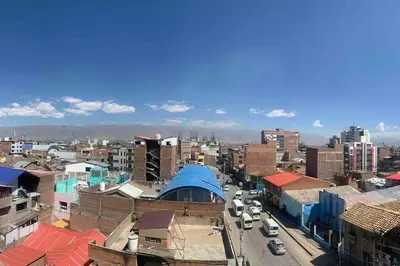 a city with buildings and cars on a street at Apartamentos WANCA SUITES para 4, 5 y 6 huéspedes cochera muy cerca al Centro in Huancayo