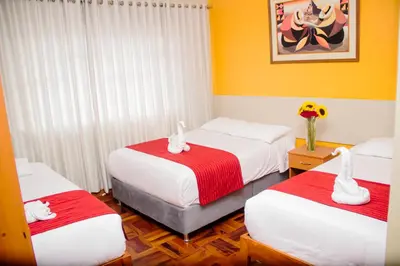 a bedroom with two beds with swans on them at HOSTAL CASA INKAS in Cusco