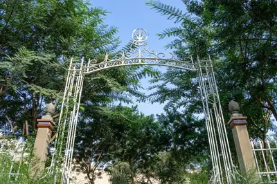 a gate at the entrance to a park with trees at Hacienda Santa María de Cieneguilla in Cieneguilla