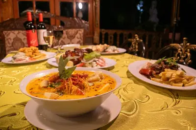 a table with a bowl of soup and plates of food at Hacienda Santa María de Cieneguilla in Cieneguilla