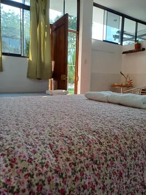 a room with a large bed with flowers on it at El Cacaotal Finca Faura #5 3H in San Ramón