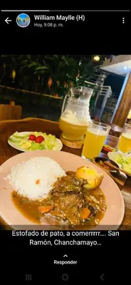 a table with a plate of food with rice and meat at El Cacaotal Finca Faura #5 3H in San Ramón