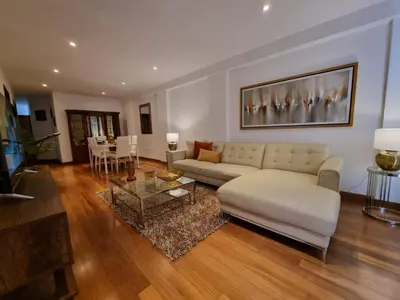 a living room with a white couch and a table at Departamento estreno 2do piso in La Molina