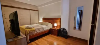 a bedroom with a bed and a television in it at Departamento estreno 2do piso in La Molina