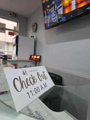 a glass table with a sign on top of it at Hotel Real San Pedro in El Puente