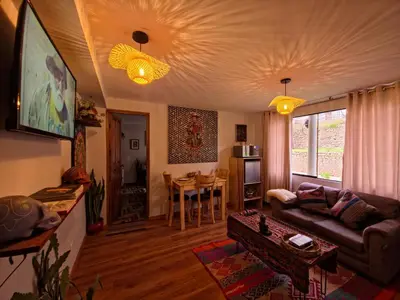 a living room with a couch and a table at Kintu Apartamento cusco in Cusco
