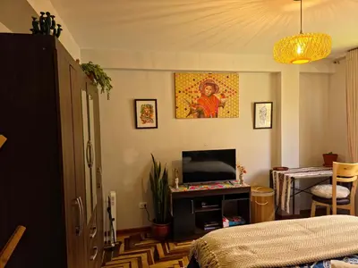 a bedroom with a bed and a tv in a room at Kintu Apartamento cusco in Cusco