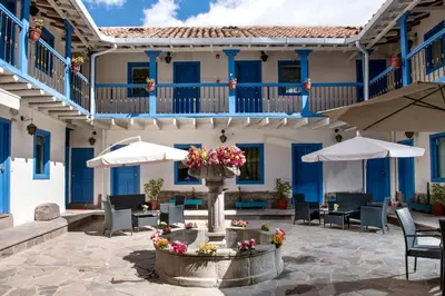 a courtyard with a fountain in front of a building at Inkarri Regocijo Plaza in Cusco
