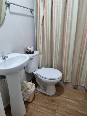 a bathroom with a white toilet and a sink at URMA 2 in Barranca
