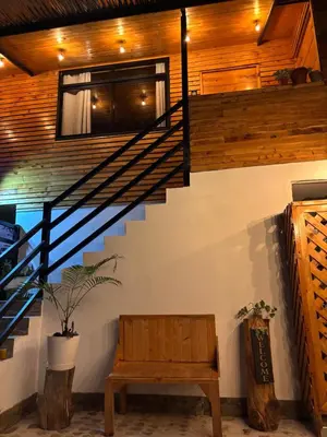 a staircase with a bench and a stair case at Carol Haus in Oxapampa