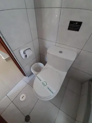a bathroom with a toilet with a sign on it at Flower's House MachuPicchu in Machu Picchu