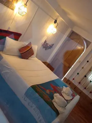 a bedroom with a bed with ducks on it at Inca Town In in Cusco