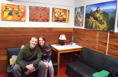 a man and a woman sitting in a room at Carlos Guest House Cusco in Cusco