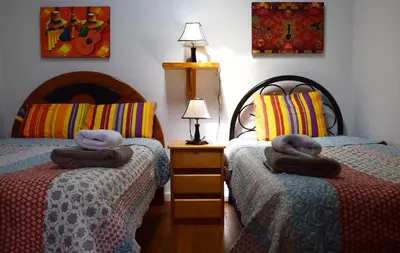 a bedroom with two beds with towels on them at Carlos Guest House Cusco in Cusco