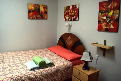 a bedroom with a bed and a lamp on a night stand at Carlos Guest House Cusco in Cusco