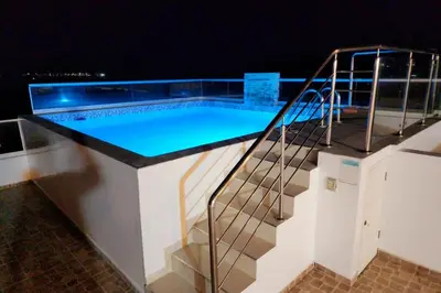 a swimming pool on top of a building at night at Casa de Playa en Cerro Azul in Cerro Azul