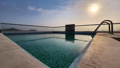 a swimming pool with a slide in the water at Casa de Playa en Cerro Azul in Cerro Azul