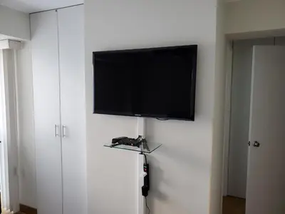 a flat screen tv on top of a white wall at New! Modern 4BR Apartment Miraflores Lima in Lima