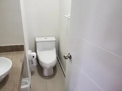 a white bathroom with a toilet and a sink at New! Modern 4BR Apartment Miraflores Lima in Lima