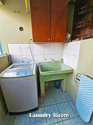 a small kitchen with a sink and a laundry room at Puma Wasi, céntrico, acogedor, bien iluminado in Cusco