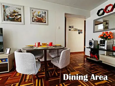 a living room with a dining room table and chairs at Puma Wasi, céntrico, acogedor, bien iluminado in Cusco